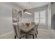 Elegant dining room featuring modern lighting, a dining table, and comfortable upholstered chairs at 10201 Los Padres Pl, Las Vegas, NV 89134