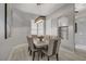 Bright dining area with modern light fixture, hardwood floors, and large window with shutters at 10201 Los Padres Pl, Las Vegas, NV 89134