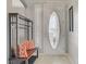 Welcoming entryway with a bench, coat rack, decorative pillows, and a stylish front door at 10201 Los Padres Pl, Las Vegas, NV 89134