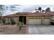 Charming single-story home with a well-manicured desert landscape, spacious driveway, and attached two-car garage at 10201 Los Padres Pl, Las Vegas, NV 89134