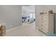 Hallway leads to the main bedroom with light wood flooring and neutral paint and offers view to office at 10201 Los Padres Pl, Las Vegas, NV 89134