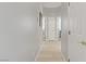 Bright hallway with laminate flooring and doorways leading to other rooms at 10201 Los Padres Pl, Las Vegas, NV 89134