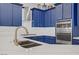 Close up of kitchen featuring blue cabinets, marble countertops, and gas range at 10201 Los Padres Pl, Las Vegas, NV 89134