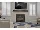 Living room featuring a fireplace with marble surround and plantation shutters at 10201 Los Padres Pl, Las Vegas, NV 89134