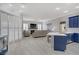 Open concept living room with fireplace, shutters, and blue kitchen at 10201 Los Padres Pl, Las Vegas, NV 89134