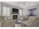 Cozy living room with a fireplace, modern furniture, and a ceiling fan at 10201 Los Padres Pl, Las Vegas, NV 89134