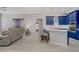 Spacious living room with modern furniture and an adjacent blue kitchen at 10201 Los Padres Pl, Las Vegas, NV 89134