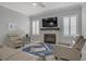 Bright living room with modern decor, a fireplace, and plush seating at 10201 Los Padres Pl, Las Vegas, NV 89134
