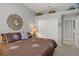 Cozy main bedroom with decorative wall mirror and closet with sliding doors for optimized space and storage at 10201 Los Padres Pl, Las Vegas, NV 89134