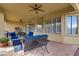 Relaxing covered patio space, complete with stylish furniture, ceiling fan, and view of the backyard at 10201 Los Padres Pl, Las Vegas, NV 89134