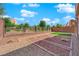 Property with gravel and rock landscaping bordered by a brick wall and iron fence, designed for low maintenance at 10254 Kesington Dr, Las Vegas, NV 89135