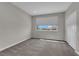 Bedroom featuring neutral carpet, bright window, and closet at 10254 Kesington Dr, Las Vegas, NV 89135