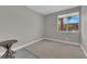 Bedroom with a patterned rug, window, and simple table at 10254 Kesington Dr, Las Vegas, NV 89135