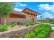 Welcoming stone entrance to the Vistara community with lush landscaping and decorative rock features at 10254 Kesington Dr, Las Vegas, NV 89135
