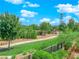 A green park featuring walkways, mature trees, and well-maintained landscaping within a residential community at 10254 Kesington Dr, Las Vegas, NV 89135