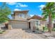A captivating two-story home showcasing desert landscaping, stone accents and a brick driveway at 10254 Kesington Dr, Las Vegas, NV 89135