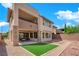 A modern two-story home boasts a covered patio, stone accents, and landscaped backyard with low-maintenance design at 10254 Kesington Dr, Las Vegas, NV 89135