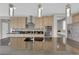 Modern kitchen island with a sink, stainless steel appliances, and sleek cabinetry with ample lighting at 10254 Kesington Dr, Las Vegas, NV 89135