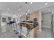 Contemporary kitchen island features bar seating, a black countertop, and stainless steel appliances at 10254 Kesington Dr, Las Vegas, NV 89135