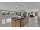 Bright, open kitchen features an island, stainless appliances, and seamless connection to the dining area at 10254 Kesington Dr, Las Vegas, NV 89135