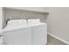 Functional laundry room with white appliances at 10254 Kesington Dr, Las Vegas, NV 89135