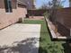 View of the backyard featuring concrete patio, artificial turf, and wood perimeter at 10719 Tottenham Ave, Las Vegas, NV 89135