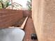 Narrow backyard space with patio table, brick walls, and low maintenance gravel at 10719 Tottenham Ave, Las Vegas, NV 89135