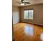 Bedroom featuring hardwood floors, natural light from a window, and neutral wall color at 10719 Tottenham Ave, Las Vegas, NV 89135