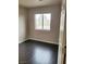 Bright bedroom with dark wood floors, natural light, and neutral paint for a cozy feel at 10719 Tottenham Ave, Las Vegas, NV 89135