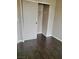 This closet features sliding doors, dark wood floors, and ample storage space at 10719 Tottenham Ave, Las Vegas, NV 89135