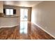 Open-plan living room and kitchen area featuring hardwood floors and neutral paint at 10719 Tottenham Ave, Las Vegas, NV 89135