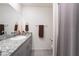 This bathroom features a granite sink with a large mirror and a shower with a curtain at 10987 Kingston Fields Ave, Las Vegas, NV 89166