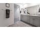 Modern bathroom with dual sinks, granite counters, and a large mirror for a luxurious feel at 10987 Kingston Fields Ave, Las Vegas, NV 89166