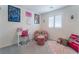 Well-lit bedroom featuring carpeted floor, a study desk and a cute chair at 10987 Kingston Fields Ave, Las Vegas, NV 89166