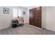 This neutral bedroom features a gray carpet, a Murphy bed, and a desk by a bright window at 10987 Kingston Fields Ave, Las Vegas, NV 89166
