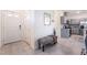 Welcoming entryway featuring a bench, decorative mirror, and view into the modern kitchen at 10987 Kingston Fields Ave, Las Vegas, NV 89166