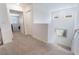 A bright hallway with carpeted floor and neutral paint creates a cohesive and inviting flow at 10987 Kingston Fields Ave, Las Vegas, NV 89166