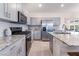 Beautiful kitchen featuring gray cabinetry, stainless steel appliances, granite countertops, and stylish backsplash at 10987 Kingston Fields Ave, Las Vegas, NV 89166