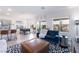 Bright living room with tile flooring, modern decor, a ceiling fan, and views into the backyard at 10987 Kingston Fields Ave, Las Vegas, NV 89166