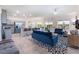 Bright, open-concept living space with modern kitchen, sleek stainless steel appliances, and stylish furnishings at 10987 Kingston Fields Ave, Las Vegas, NV 89166