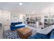 Bright living room with tile flooring and an open concept to the kitchen and dining areas at 10987 Kingston Fields Ave, Las Vegas, NV 89166