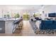 Open floor plan featuring a modern kitchen with a center island and a stylish living area at 10987 Kingston Fields Ave, Las Vegas, NV 89166