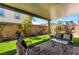 Covered patio with brick base, artificial turf, brick wall, and outdoor furniture at 10987 Kingston Fields Ave, Las Vegas, NV 89166
