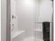 A spacious shower with tiled walls, glass door and a built-in seat create a spa-like experience at 10987 Kingston Fields Ave, Las Vegas, NV 89166