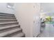 Carpeted stairs leading to the upper level, with a view of the kitchen and backyard at 10987 Kingston Fields Ave, Las Vegas, NV 89166