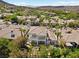 Aerial view showcases the property, pool, and lush landscaping in a desirable neighborhood at 11 Caminito Amore, Henderson, NV 89011