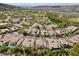 Expansive aerial view of a luxury community with pools, golf course, and mountain views at 11 Caminito Amore, Henderson, NV 89011