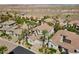 An aerial view features desert landscaping and tile roofed houses in a planned community at 11 Caminito Amore, Henderson, NV 89011