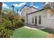 Home backyard with a manicured lawn, lush landscaping, and a covered patio at 11 Caminito Amore, Henderson, NV 89011