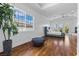 Spacious bedroom with wood floors, tray ceiling, and large windows overlooking the backyard at 11 Caminito Amore, Henderson, NV 89011